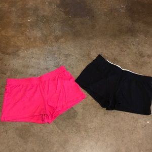 A pair of pink and black workout shorts